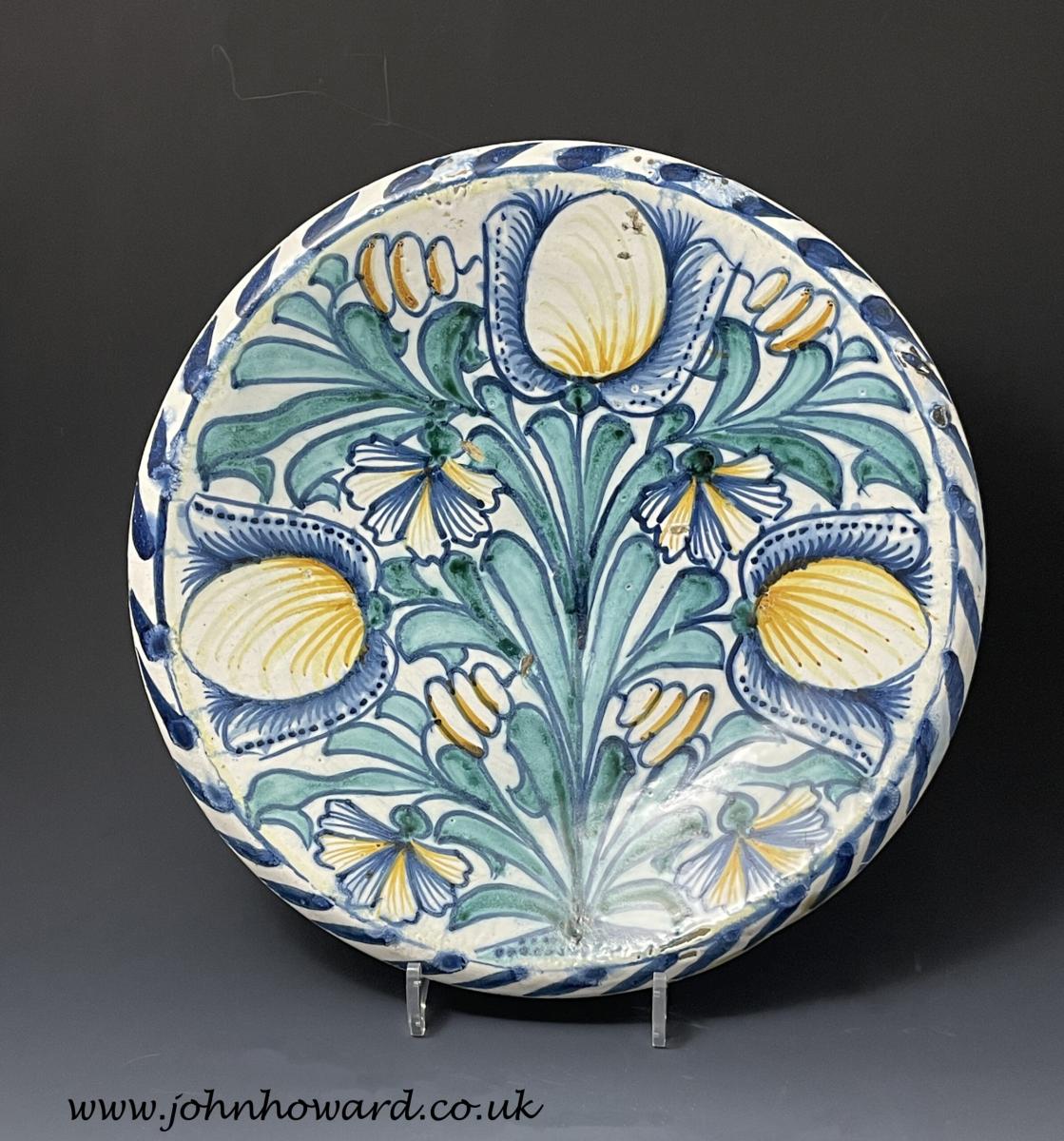 English delftware blue dash charger painted with tulips London circa 1675