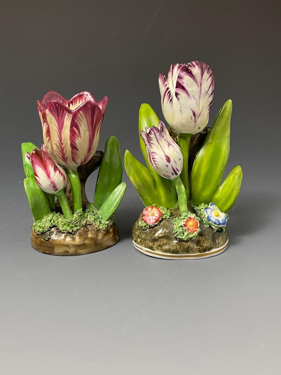 A collection of four Staffordshire models of tulips standing amongst flowers and leaves. circa 1825