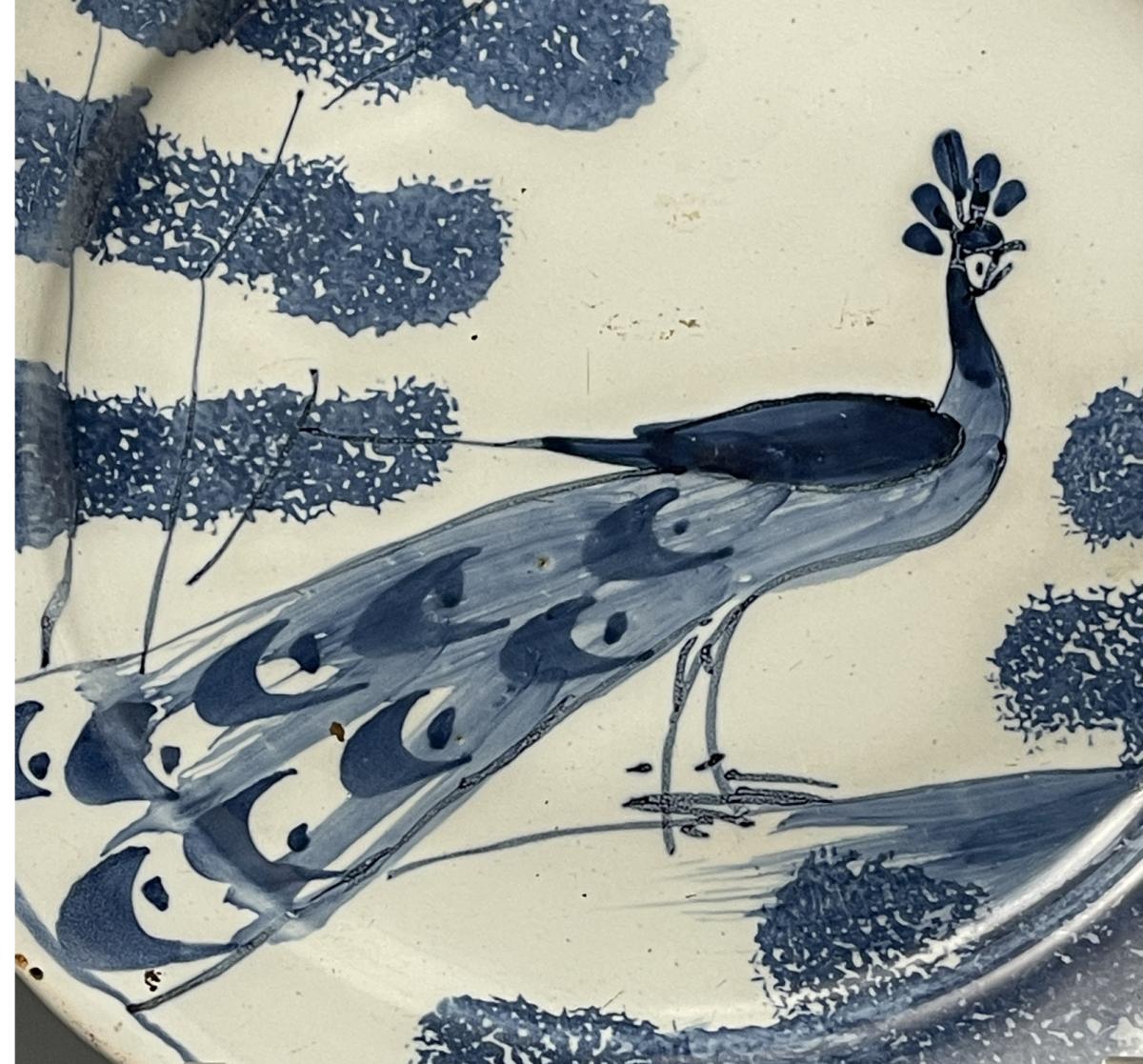 Bristol delftware blue and white plate with peacock and trees from the farmyard series mid 18th century