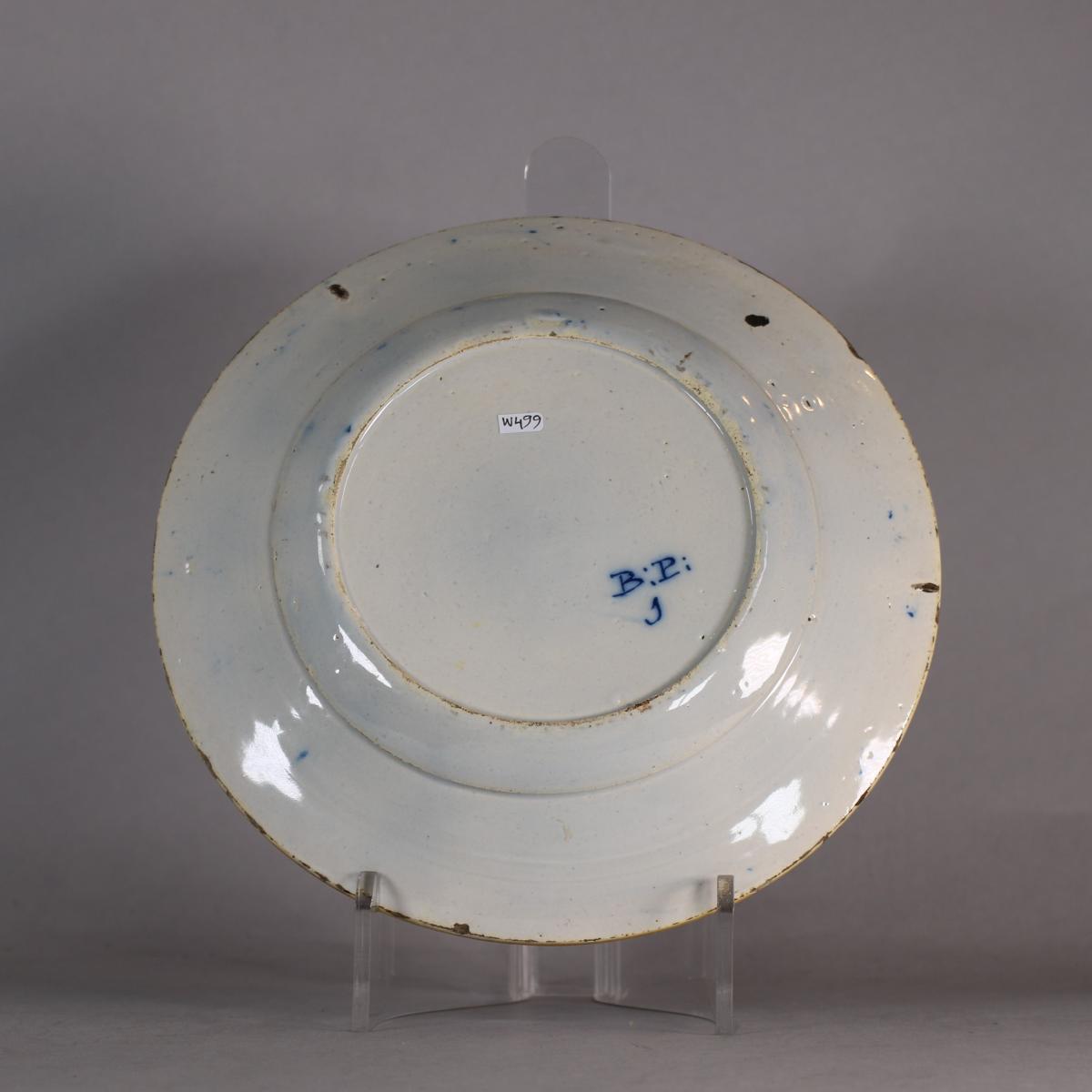 Reverse of dutch delft peacock charger