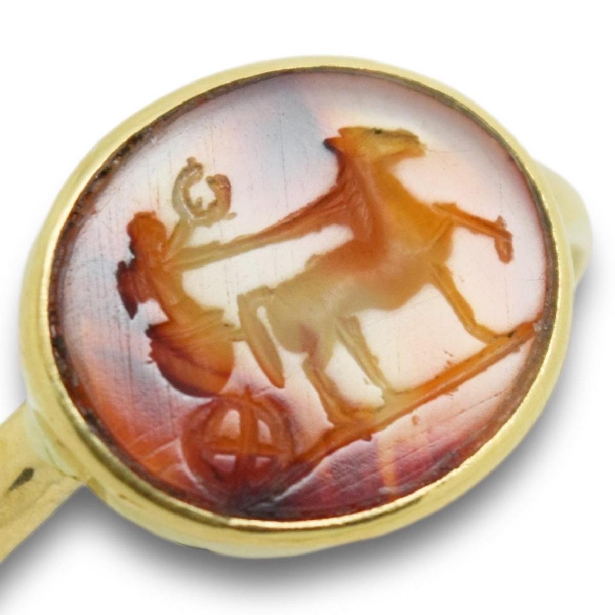 Roman carnelian intaglio ring of Cupid riding a chariot