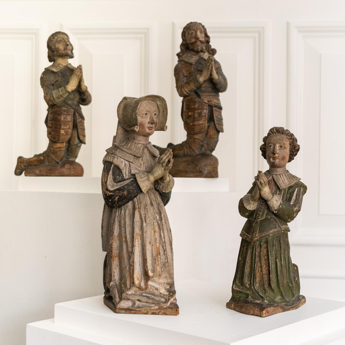 A rare family group of four polychromed limewood kneeling figures, English, circa 1610-1630