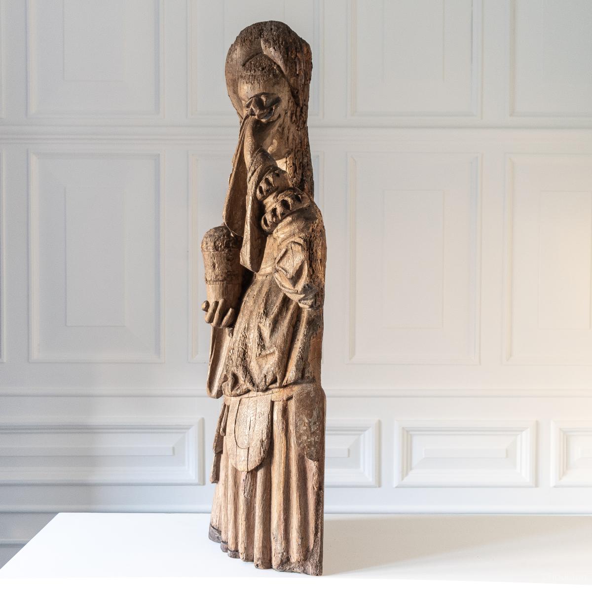 A fine carved oak figure, Mary Magdalene, traces of polychrome, Southern Netherlandish, Eastern France or South Western Germany, circa 1400-1425