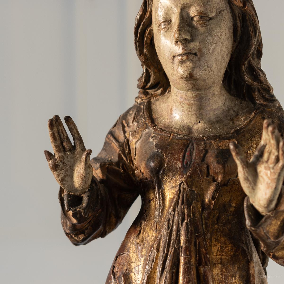 A gilt and polychromed limewood figure, Saint Mary Magdalene, South German, circa 1515