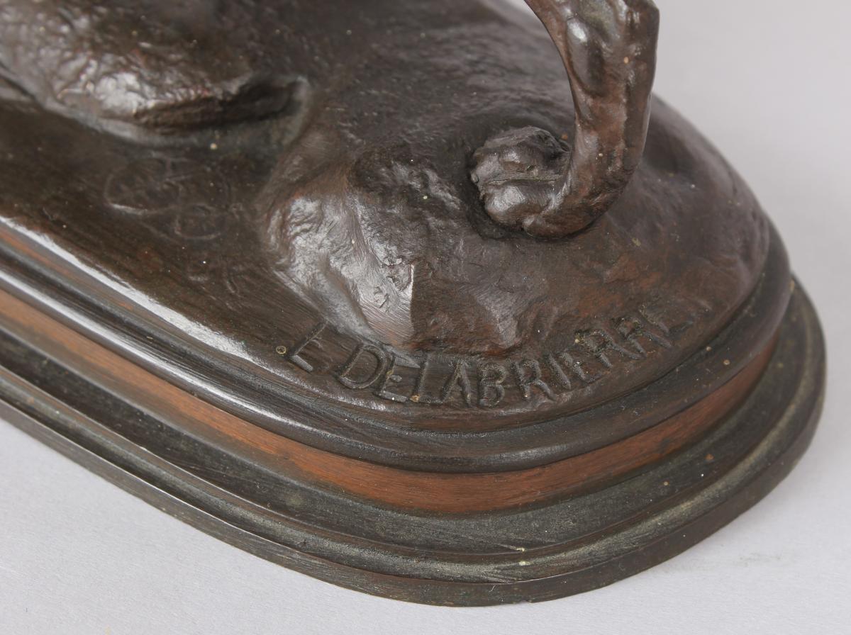 A fine bronze sculpture of a gun dog with a duck resting