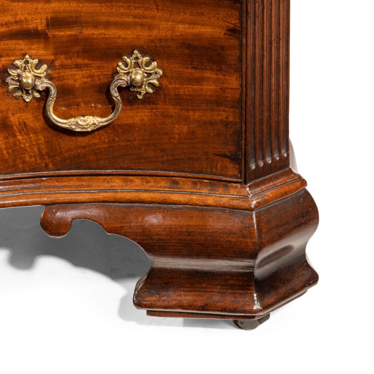 A flame mahogany George III serpentine chest of drawers
