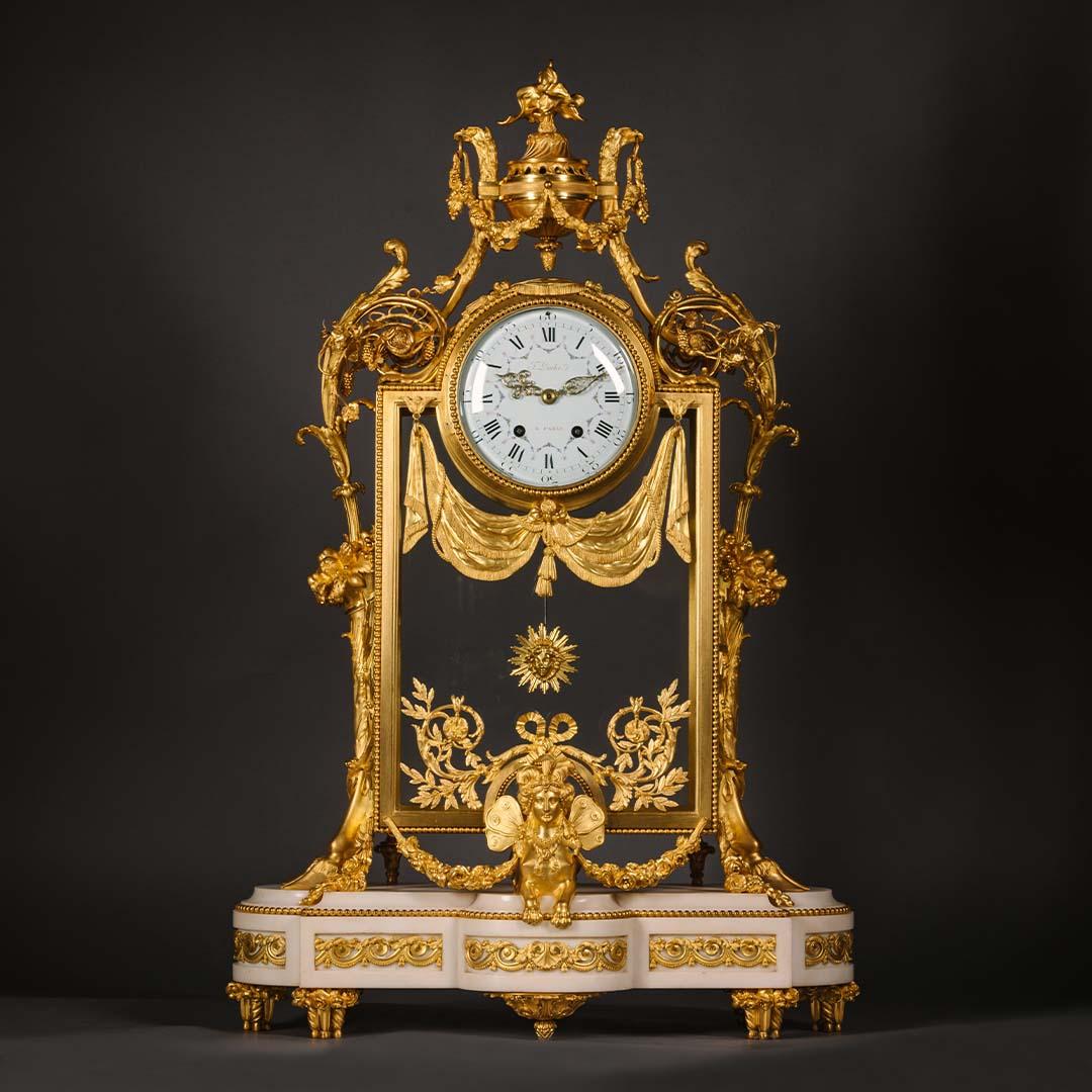 A Louis XVI Style Gilt-Bronze and Glass Pendule A Cage
