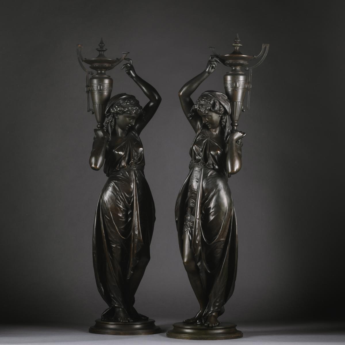 A Pair Of Napoleon III Patrinated-Bronze Figures, Modelled As Classically Robed Maidens Bearing Urns, by Victor Paillard (French, 1805-1886)