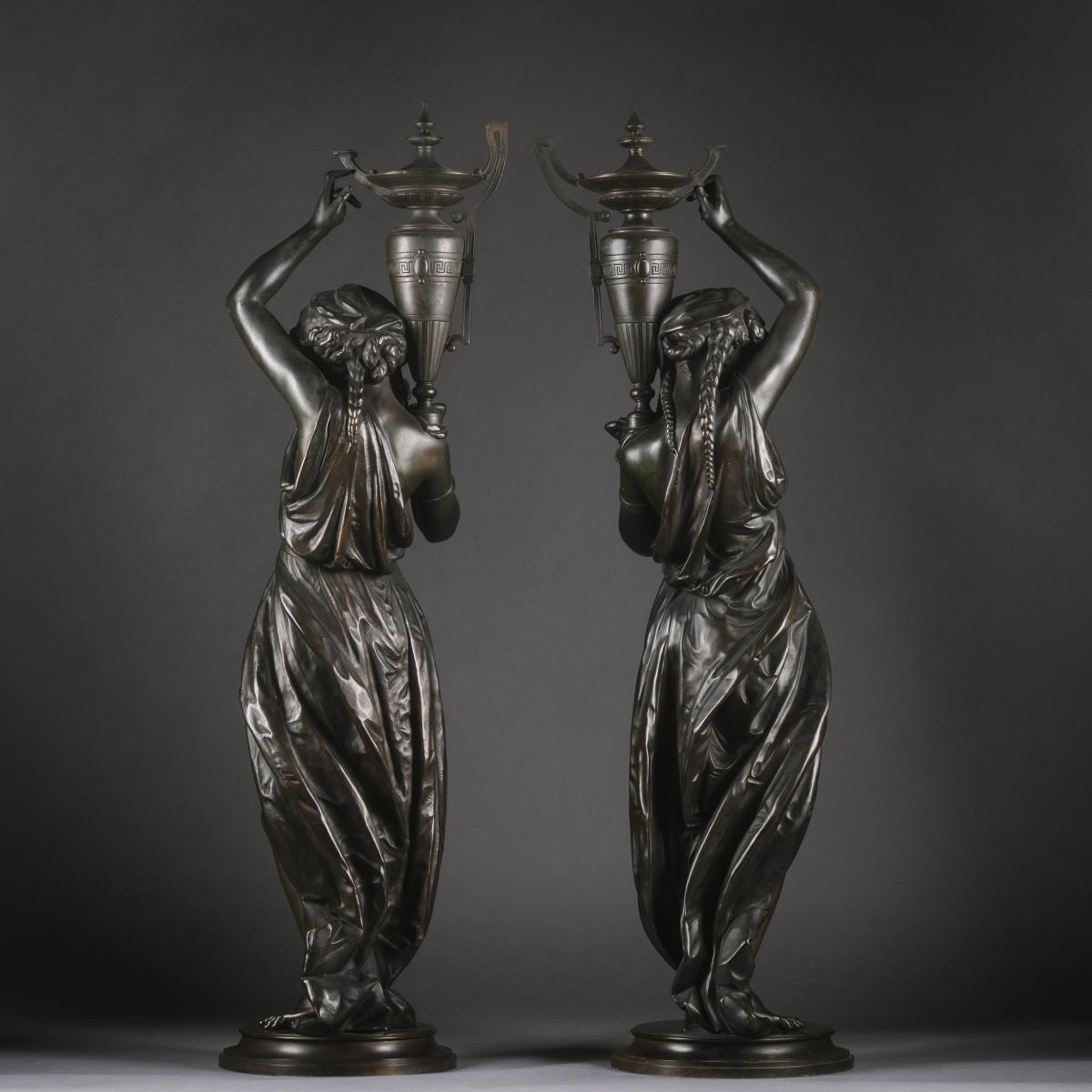 Victor Paillard (French, 1805-1886) A Pair Of Napoleon III Patrinated-Bronze Figures, Modelled As Classically Robed Maidens Bearing Urns 