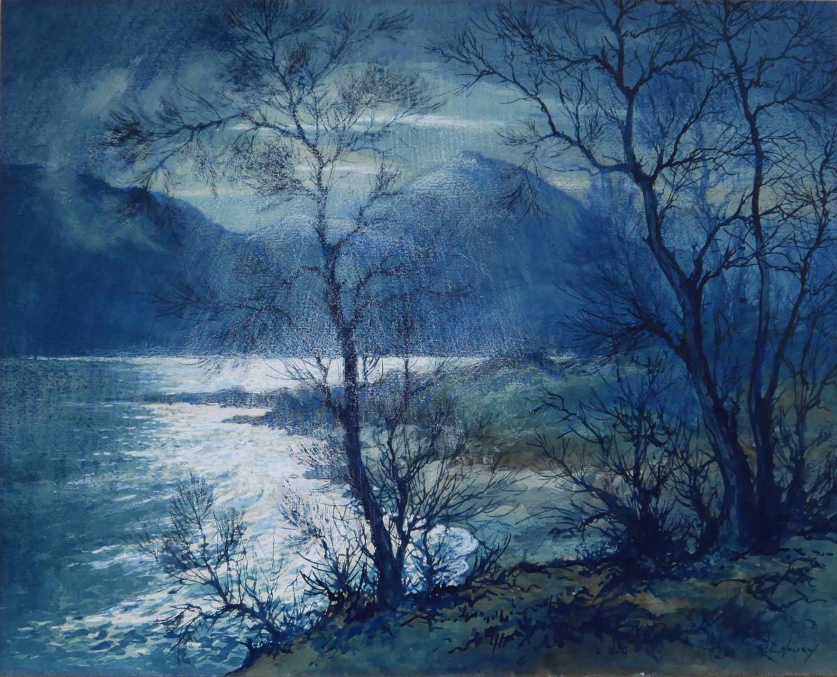 Moonlight creating dramatic effect on the shores of a lake in the Lake District.