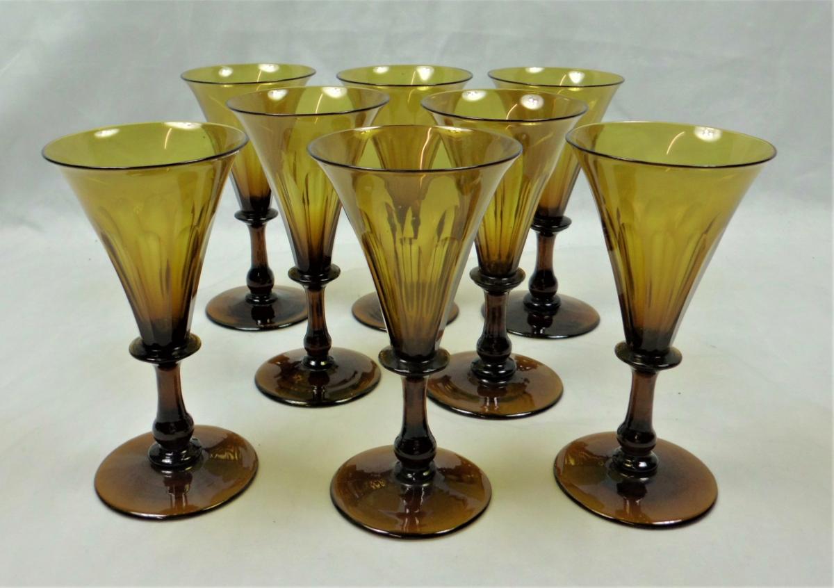 A rare set of amber (straw) coloured Regency period wine glasses