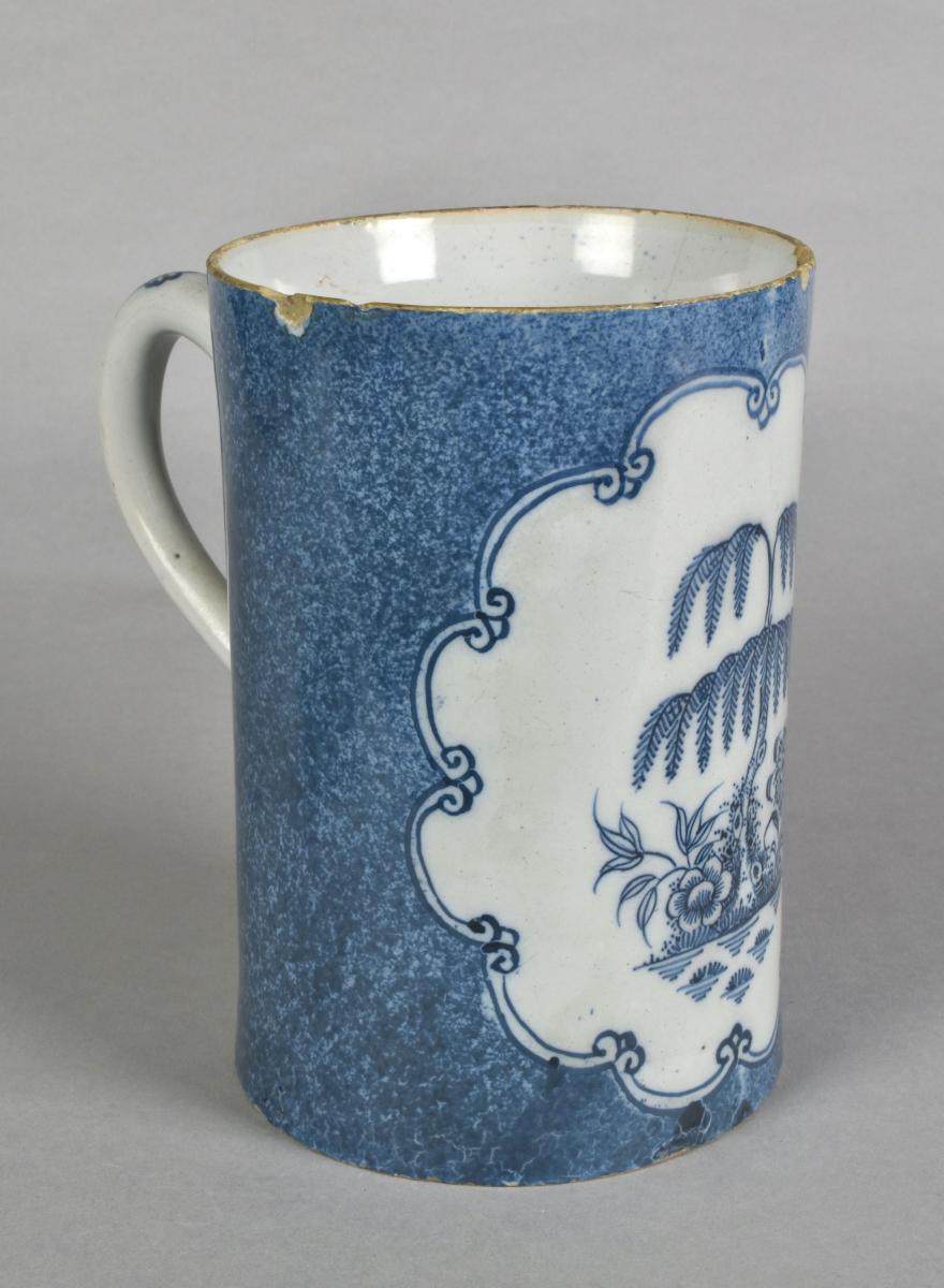An unusual English blue and white delft tankard with a powdered blue ground, c.1775