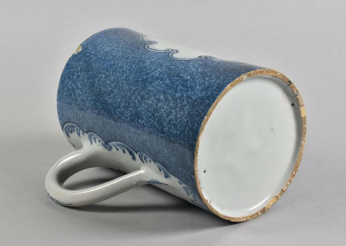 An unusual English blue and white delft tankard with a powdered blue ground, c.1775