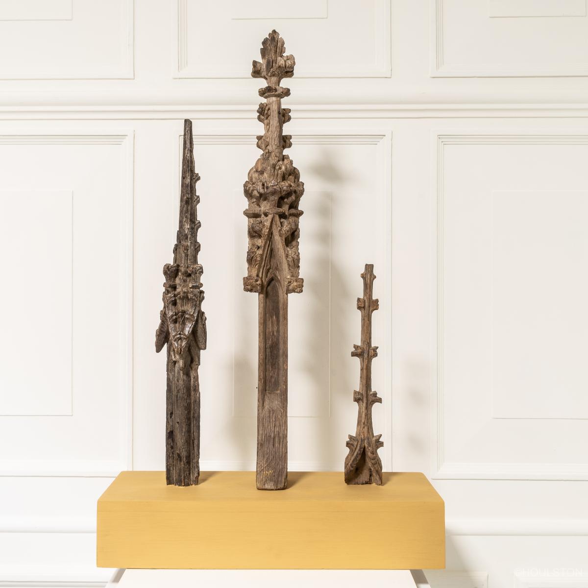 three carved oak medieval crocketed finials on a painted stand