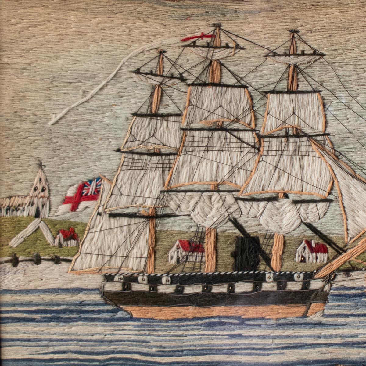 A 19th century wool embroidery of a ship in a painted frame