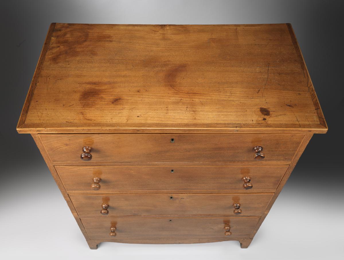 Refined Georgian Vernacular Chest of Four Long Drawers With Shaped Apron and Original Turned Wood Handles  Solid Elm with Boxwood Stringing to the Top and Drawer Fronts  English, c.1800