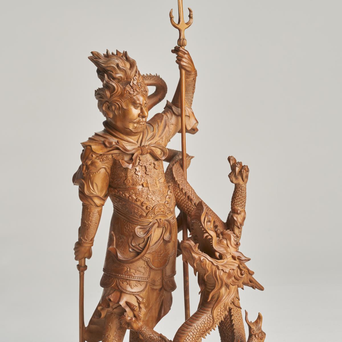 A dramatic and intricately carved wood Okimono of Ryujin, the Dragon God of the Sea (1880)