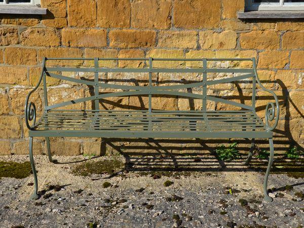 A 19th century wrought iron strap work garden seat