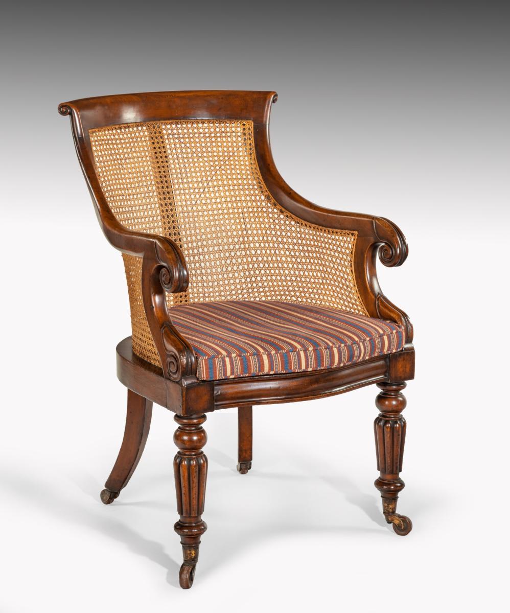 Antique carved mahogany bergere armchair