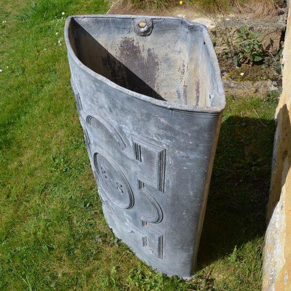 An 18th century lead corner cistern of triangular form