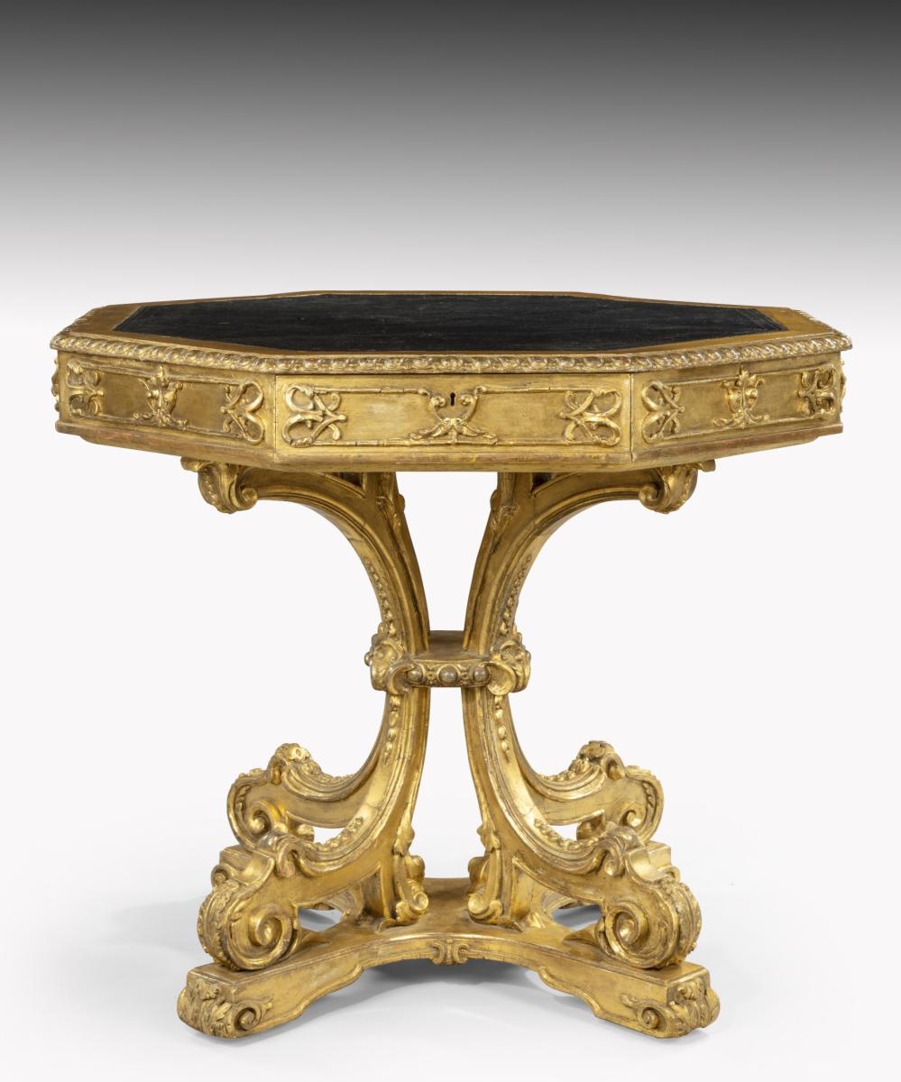 Antique drum table decorated in giltwood