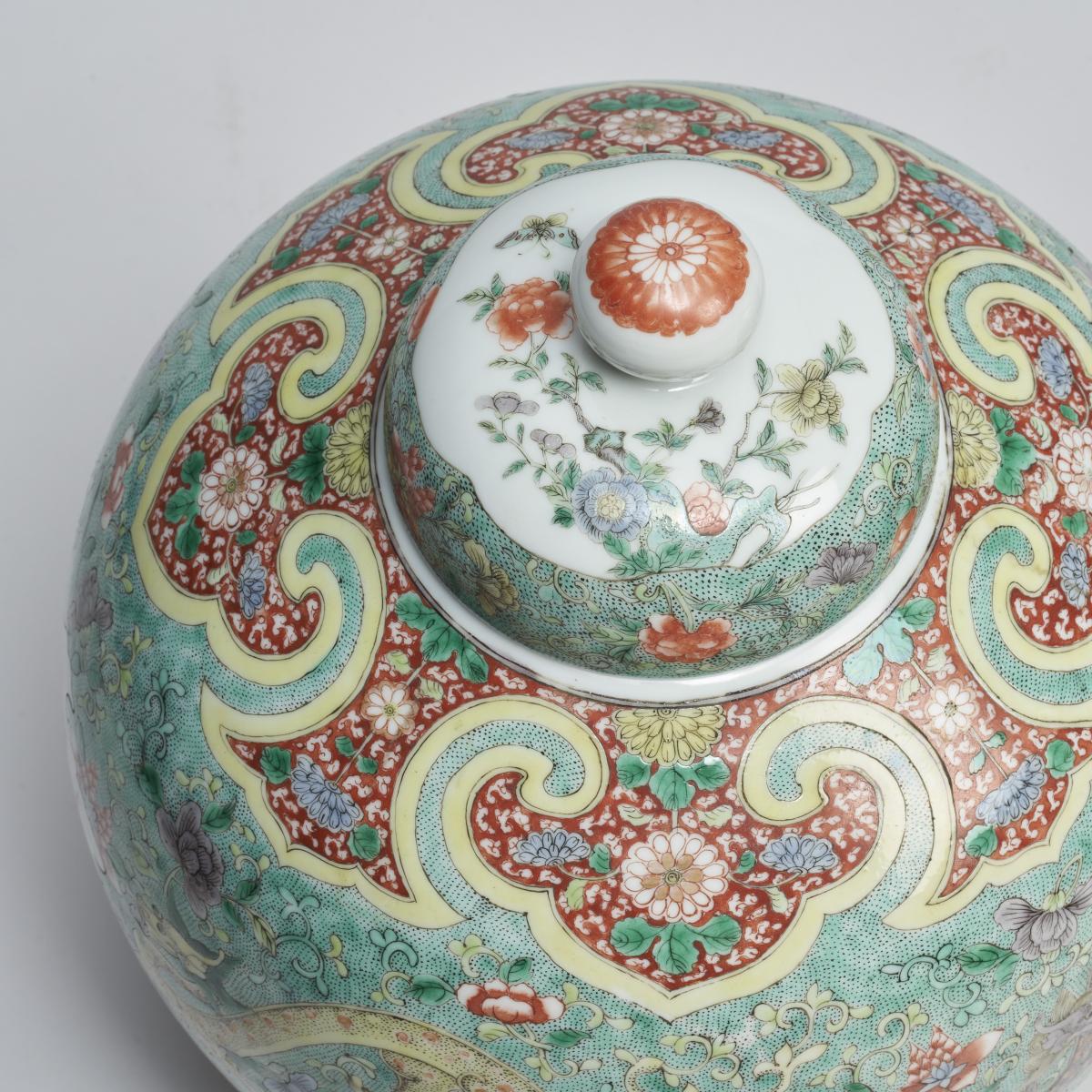 A finely painted pair of Chinese 19th Century famille verte jars and covers