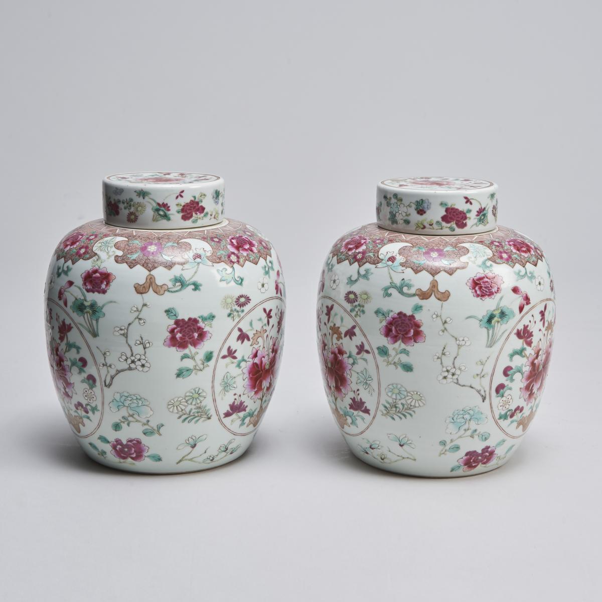 An ornate pair of 19th Century Chinese famille rose jars and covers