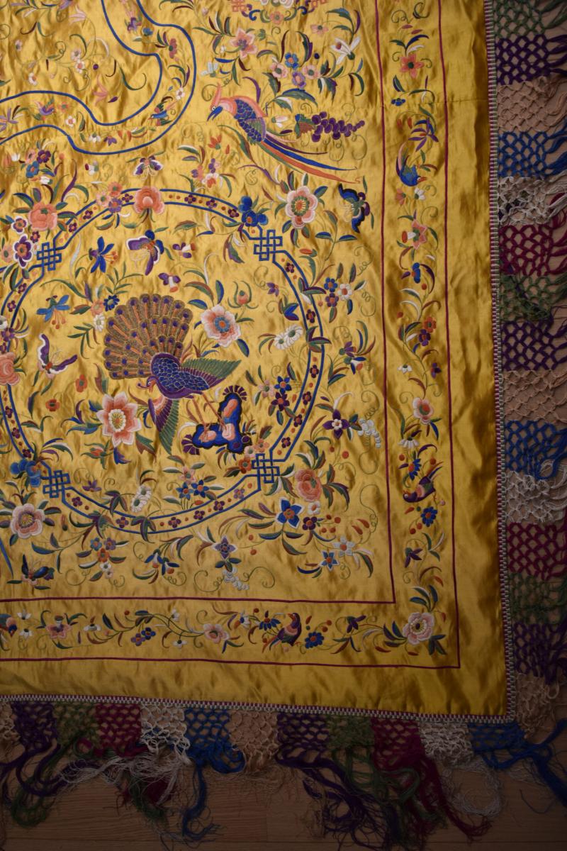 Embroidered bed cover on a yellow silk background