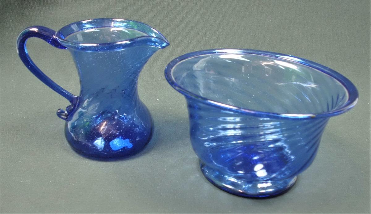 Blue glass sugar bowl and cream jug with wrythen decoration, North of England circa 1790