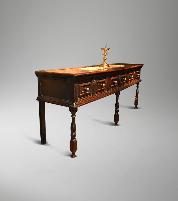 An impressive Charles II oak low dresser