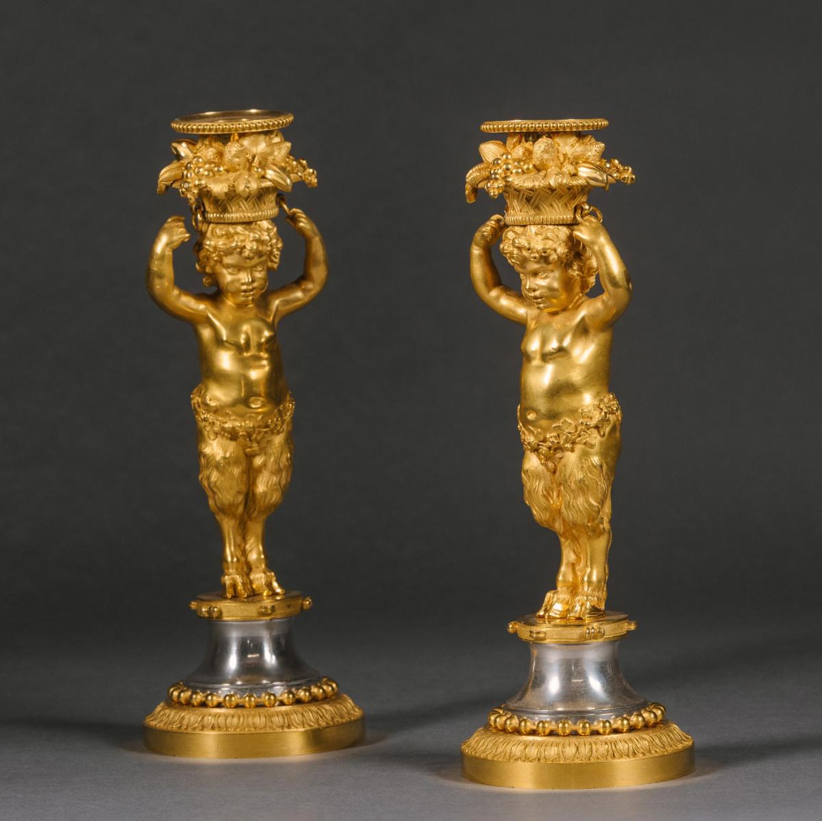 A Pair of Louis XVI Style Gilt-Bronze and Polished Steel Candlesticks By Maison Beurdeley.