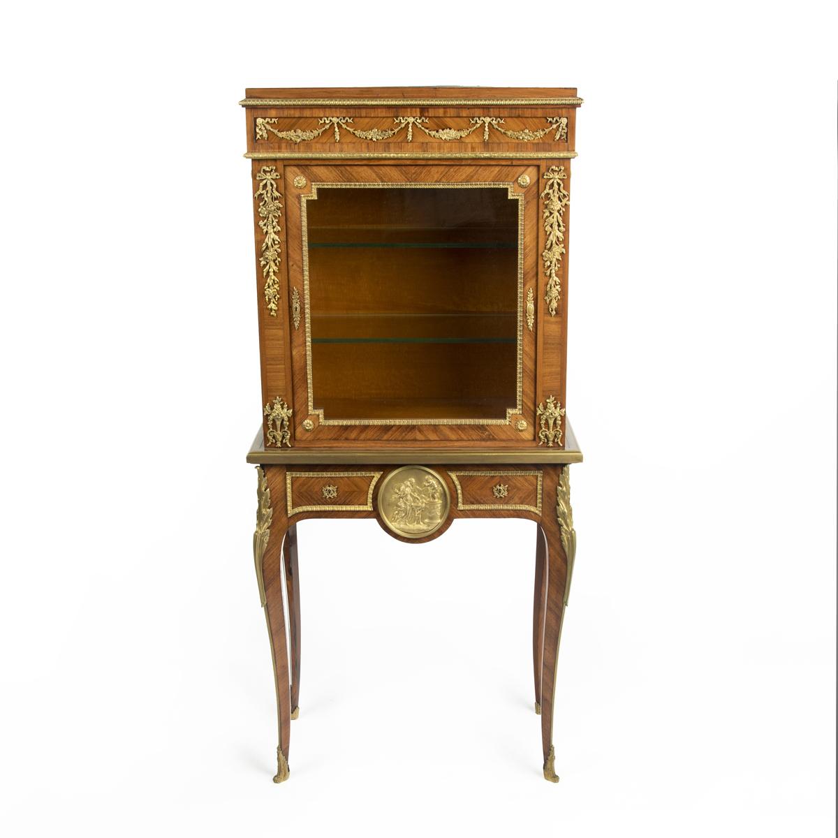 A pair of small Napoleon III kingwood display cabinets on stands