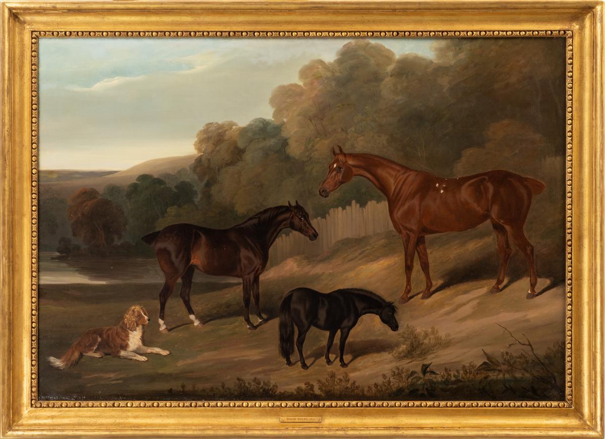 A dark bay hunter, a bay hunter, a black pony and a spaniel in an extensive landscape