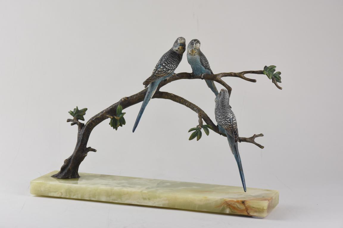 An Austrian cold painted bronze group of 3 blue Budgerigars perched on branches
