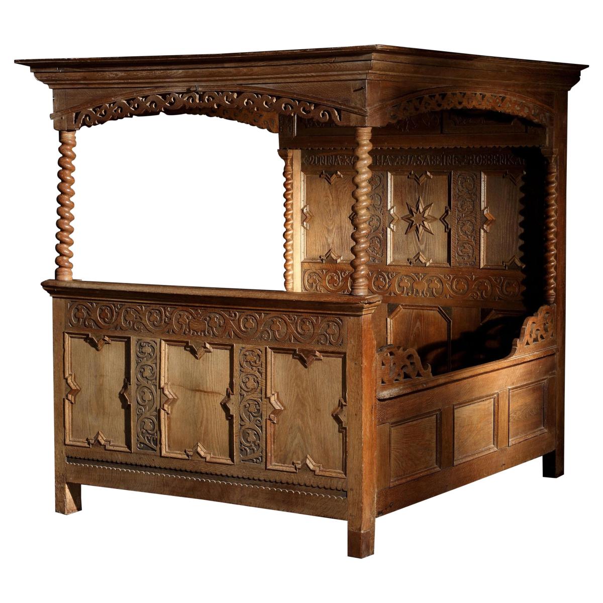 A mid-17th century, oak, tester, double bed with cupboard in the headboard, retaining its original iron fasteners