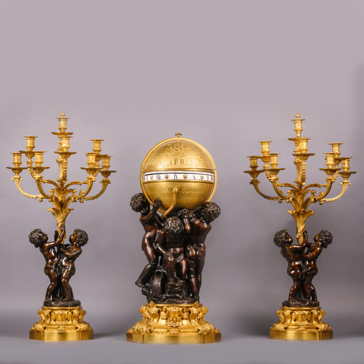 A Gilt and Patinated Bronze Cercles Tournants Clock Garniture, by Deniere, Paris for sale at Adrian Alan Ltd