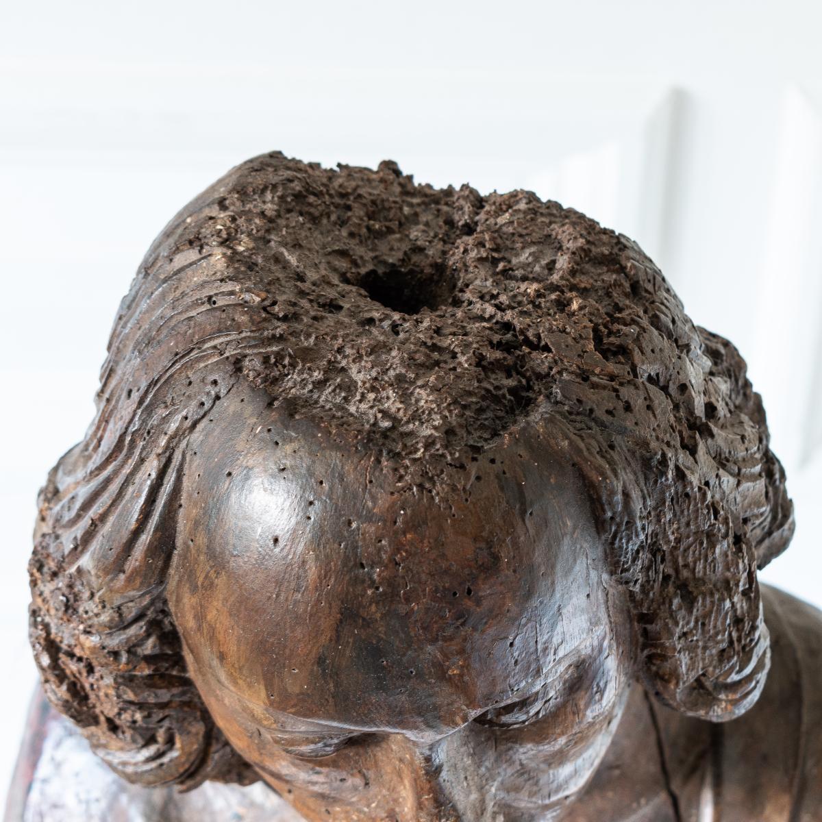 Detail of the top of the head of a carved walnut figure