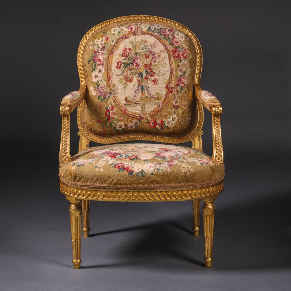 A Pair of Louis XVI Style Giltwood and Tapestry Fauteuils. France, Circa 1870. Adrian Alan Ltd