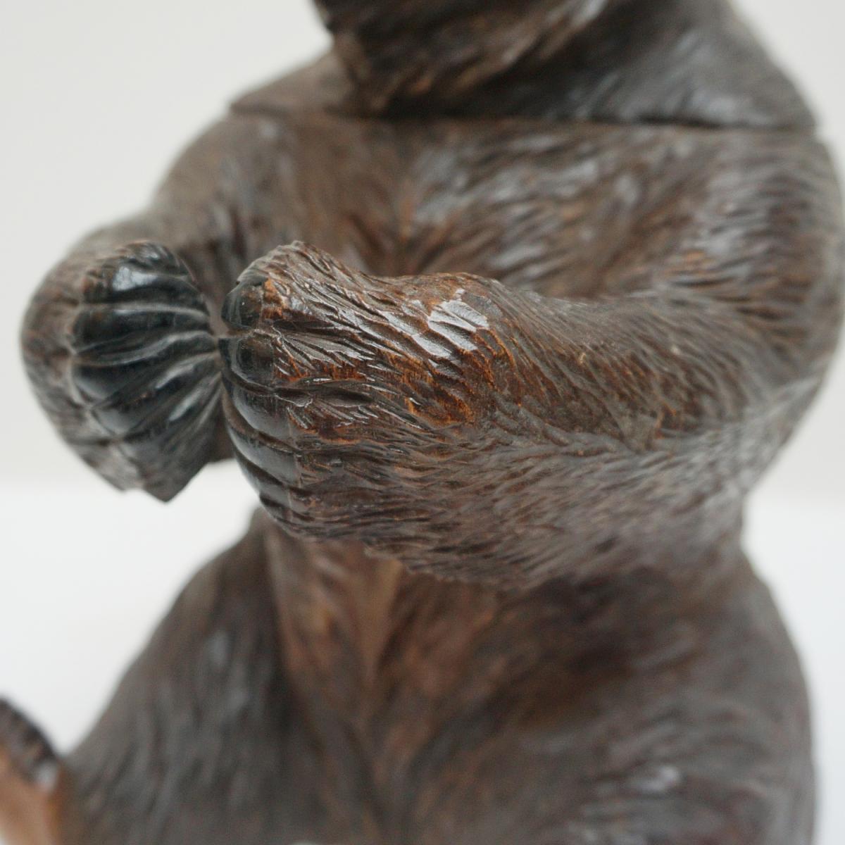 A Black Forest seated carved bear as a tobacco jar