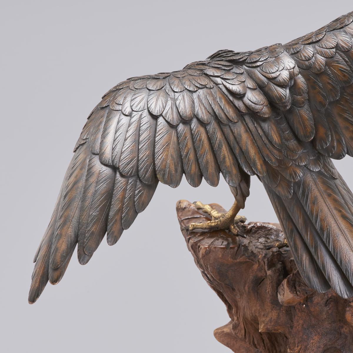 Japanese bronze hawk perched on a root wood base signed Gyoko, Meiji Period