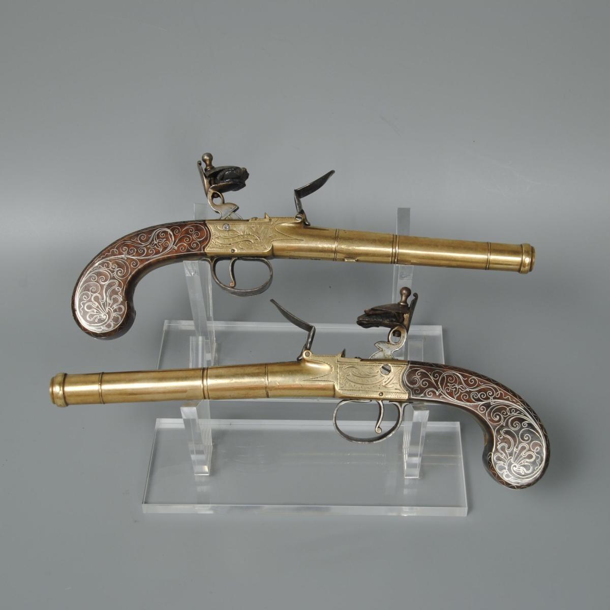 A Fine Pair of Silver Inlaid Brass Barrelled Pistols By Bunney London