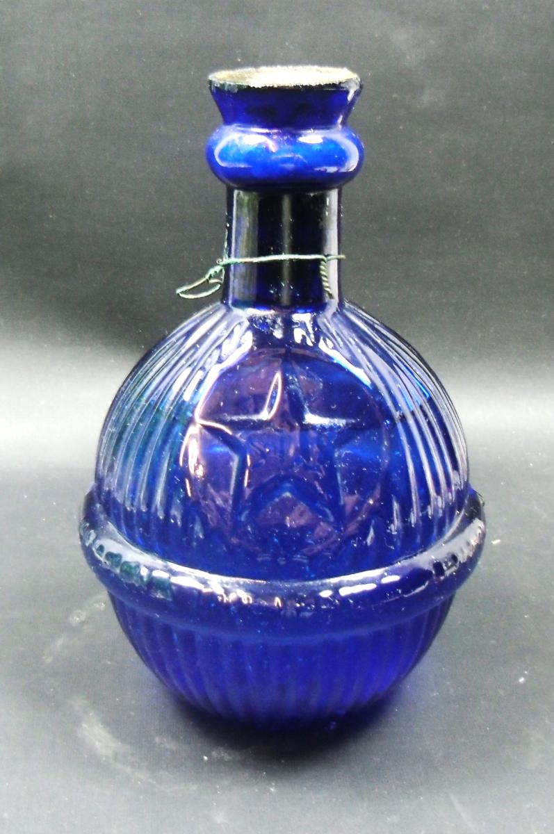 A blue glass Hardens Star fire grenade, sealed and full, English circa 1890