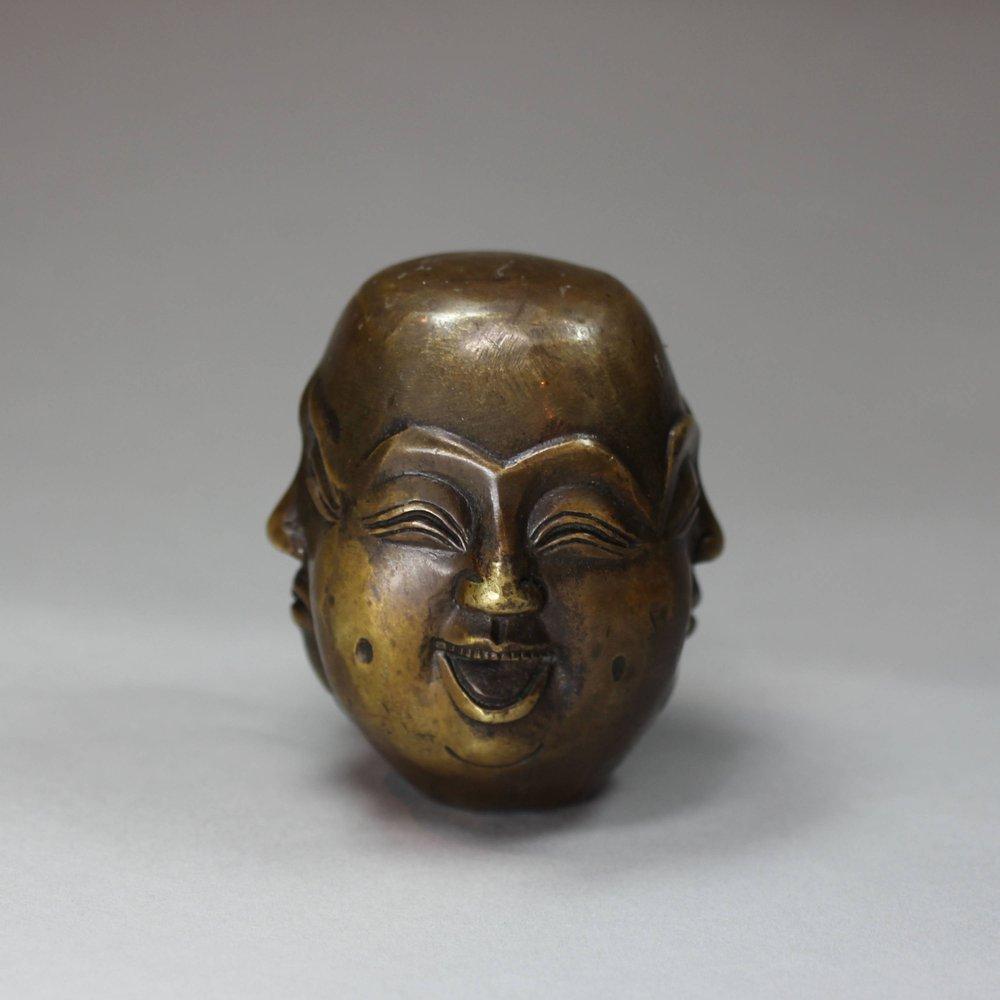 Detail of happy expression on Chinese brass desk seal