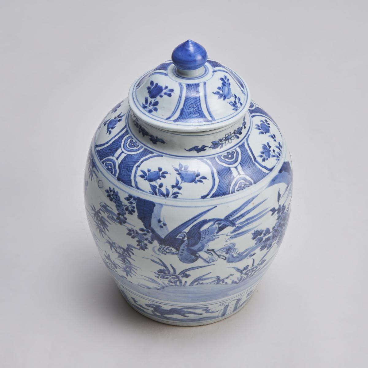 A large, early 19th Century Chinese blue and white covered porcelain jar with interesting decoration