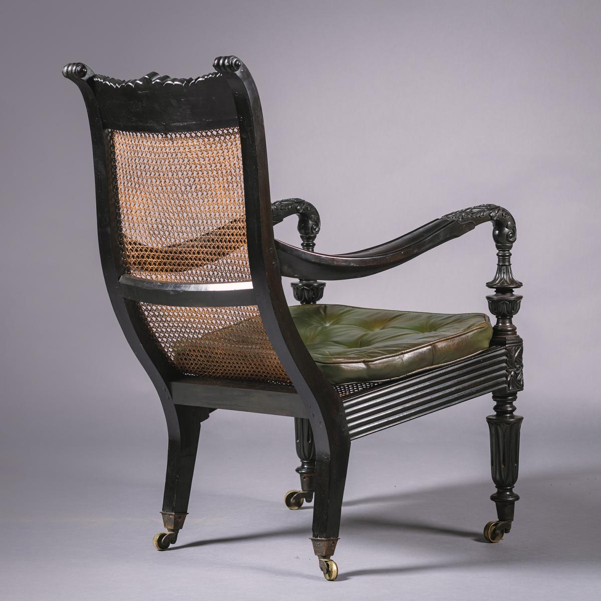 Two Anglo-Indian Carved Ebony Easy Armchairs
