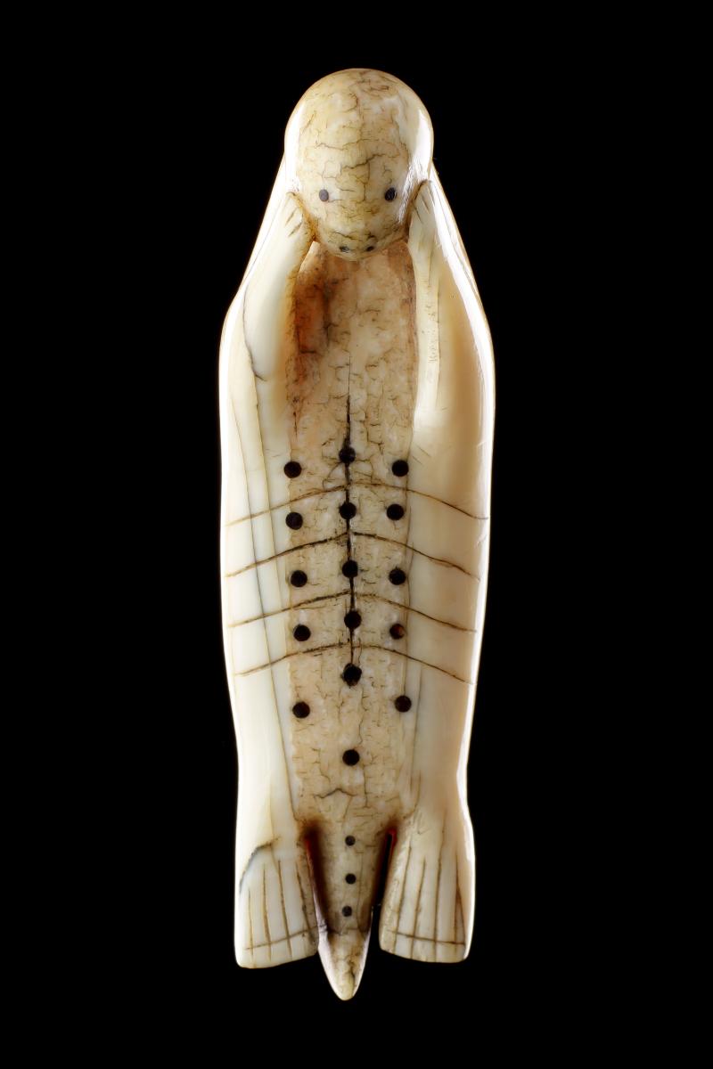Inuit Amulet of a Seal Laying on His Back with Flippers Cradling His Face