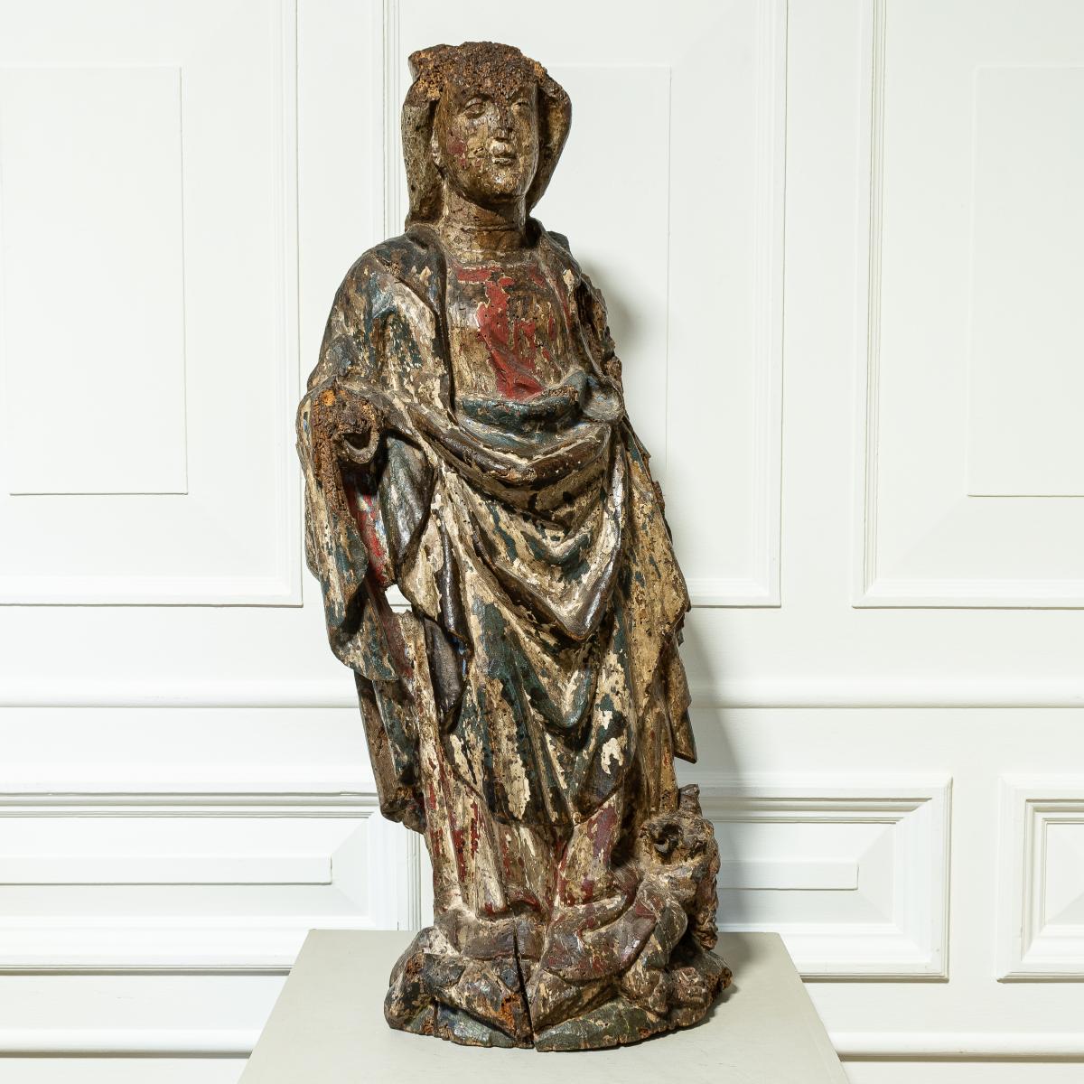 A 15th century polychromed limewood carving of Saint Barbara, Flemish, circa 1500