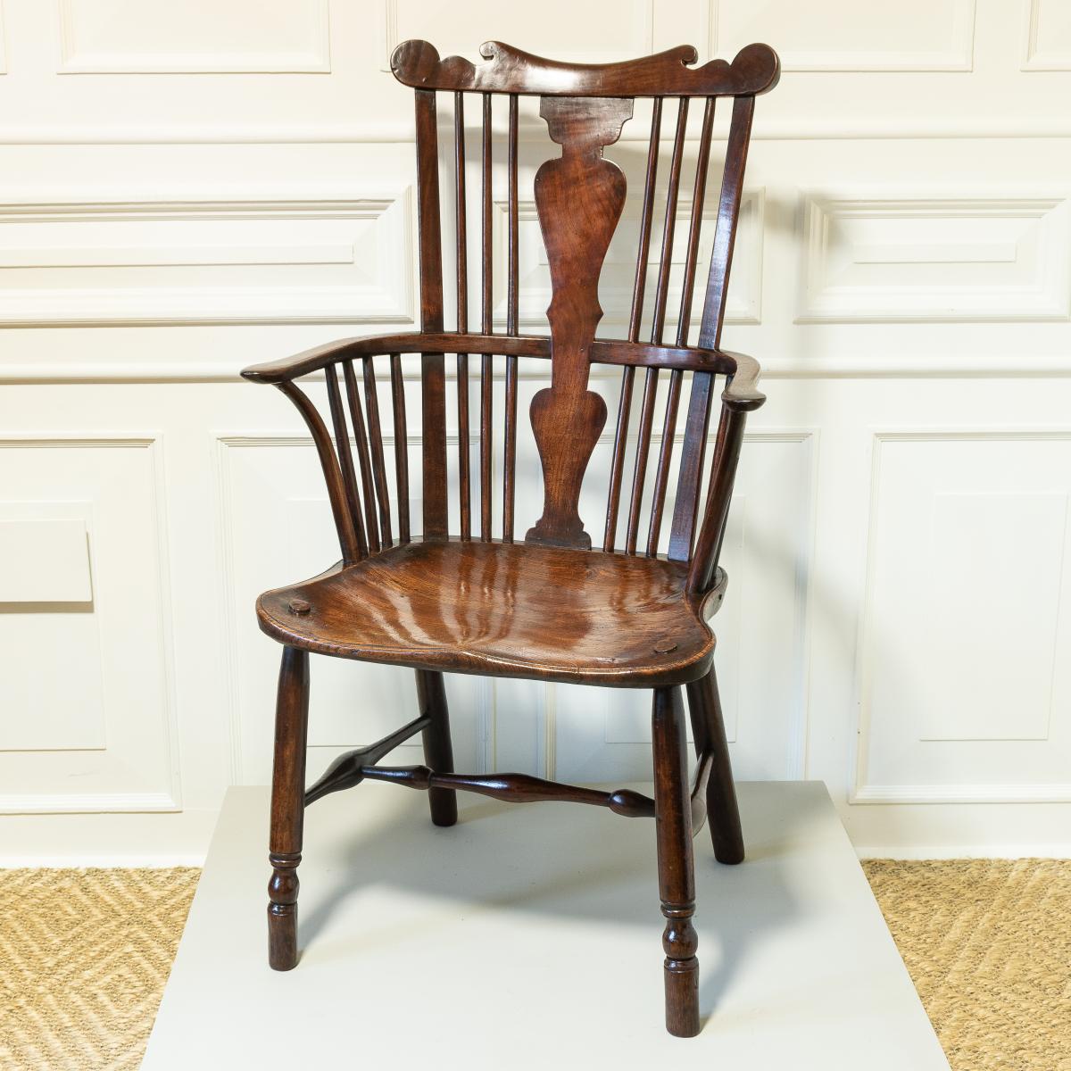 A George III fruitwood comb-back Windsor armchair, Thames Valley, circa 1780