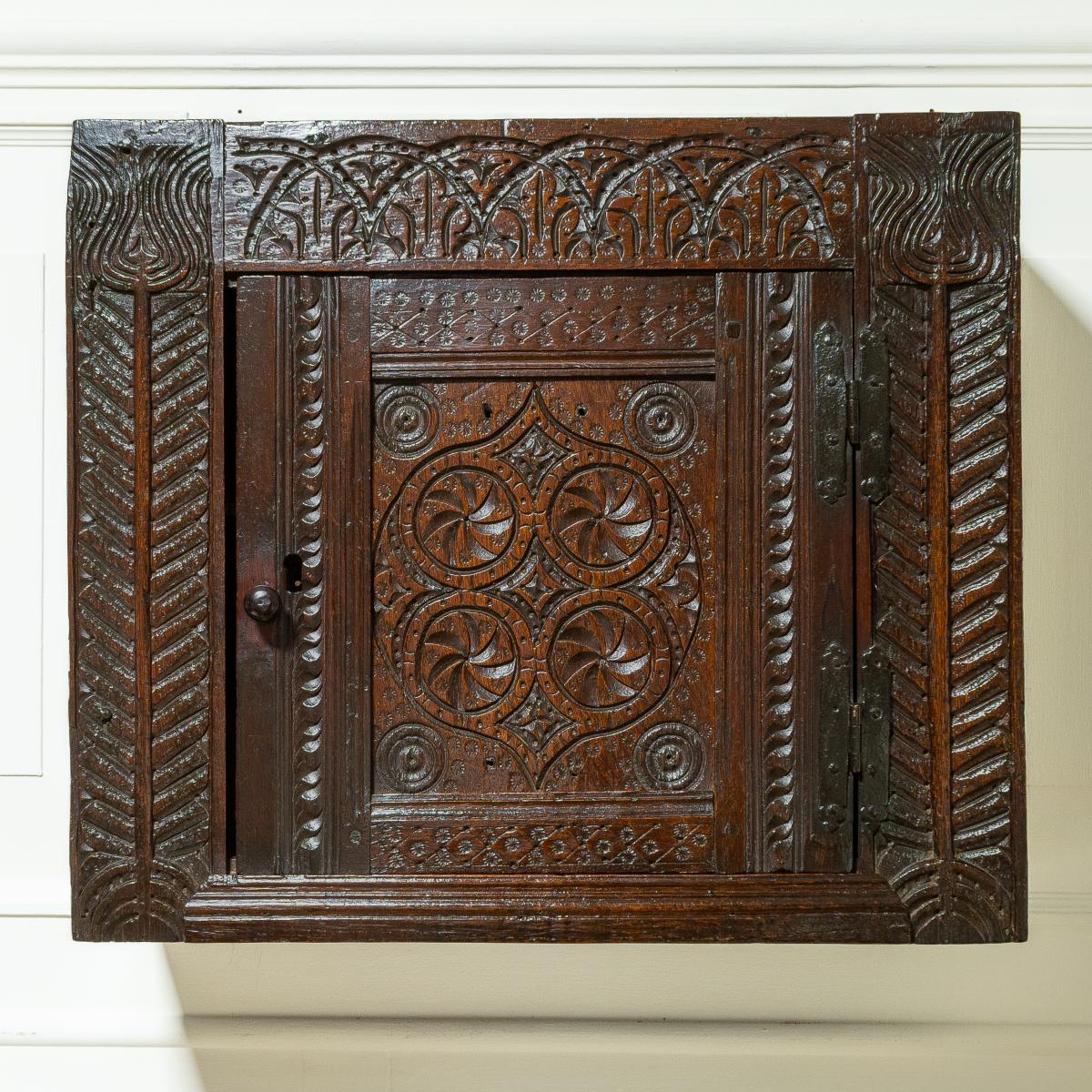 A good Charles I boarded and joined oak and elm mural cupboard, Gloucestershire, circa 1630