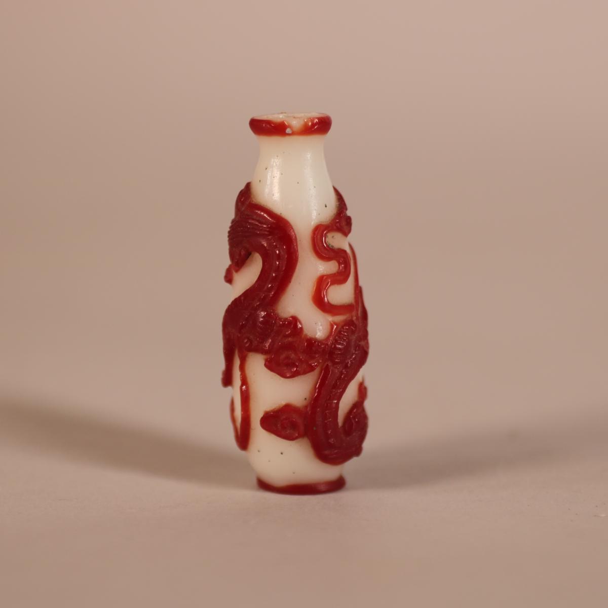 Other side of qing glass snuff bottle with red overlay